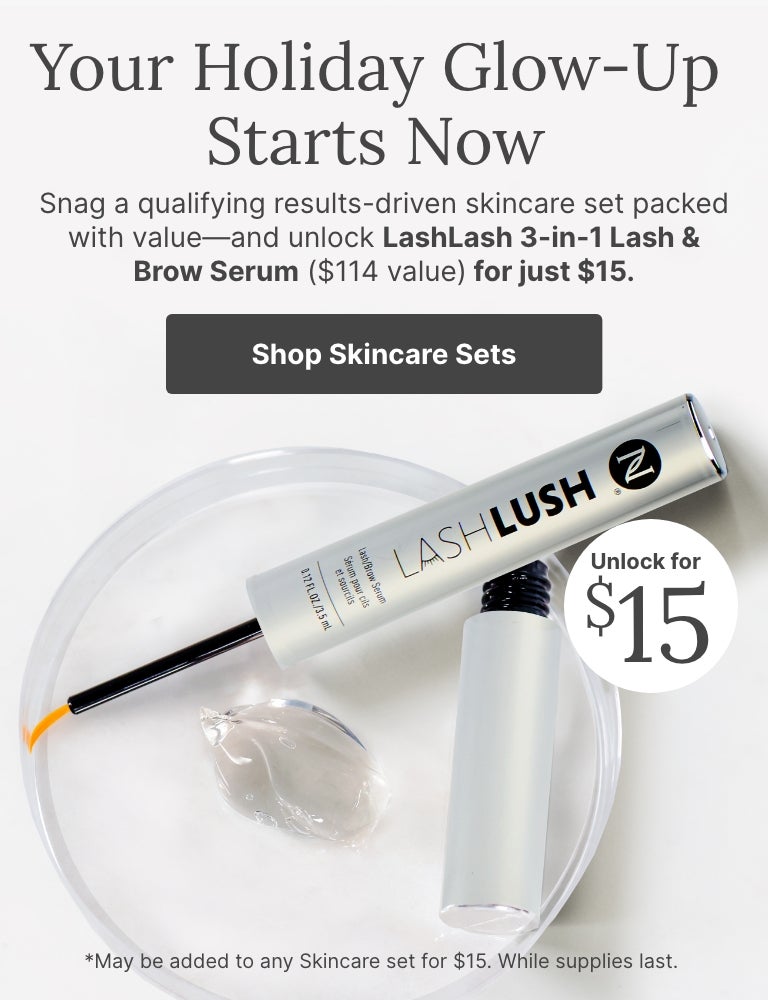 Holiday skincare promotion featuring LashLash 3-in-1 Lash & Brow Serum on a clear dish with gel, highlighting limited-time $15 offer ($114 value) when purchased with qualifying skincare sets.